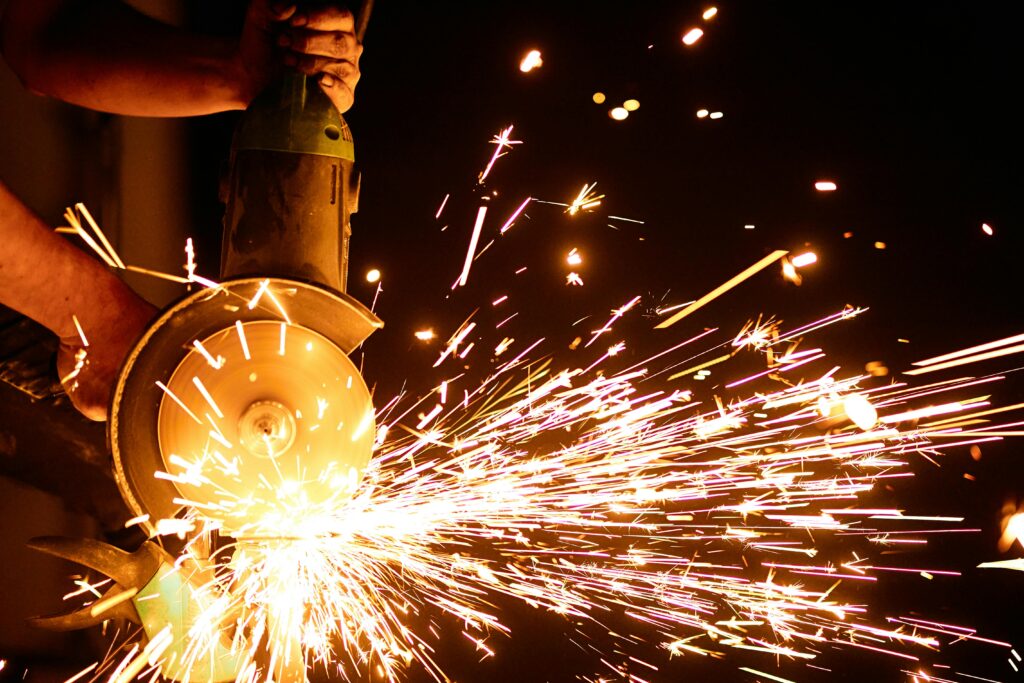Dynamic shot of an angle grinder emitting bright sparks, showcasing industry power and motion.